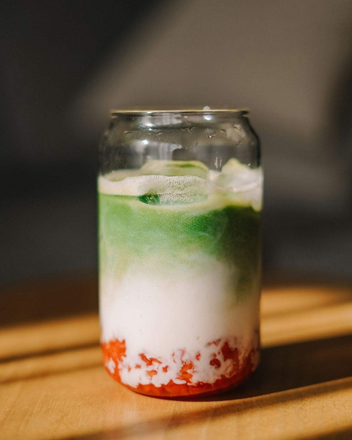 Strawberry Cloud Matcha — Macerated strawberry beneath a soft cream cloud and a layer of ceremonial matcha. Quietly indulgent, built to be looked at before it is tasted.