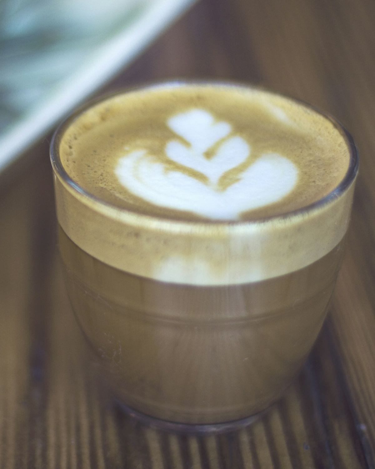 Vanilla Cream Latte — Specialty espresso, steamed milk and real vanilla, finished with a thin band of cold cream. Warm, rounded, unhurried.